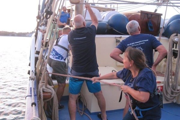 Członkowie IV wachty stawiają topsla bezana, na pierwszym planie Bożenka ciągnie linę