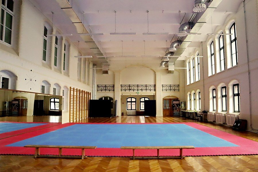 wnętrze salu gimnastycznej w Pałacu Młodzieży, na środku duż mata niebiesko-czerwona