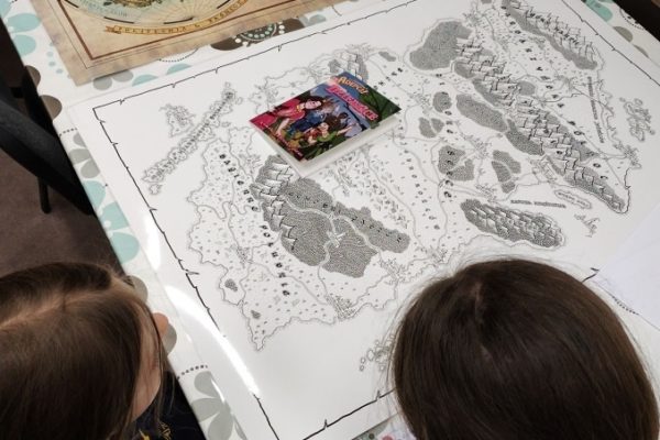 dwóch uczestników pochylonych nad rysunkiem