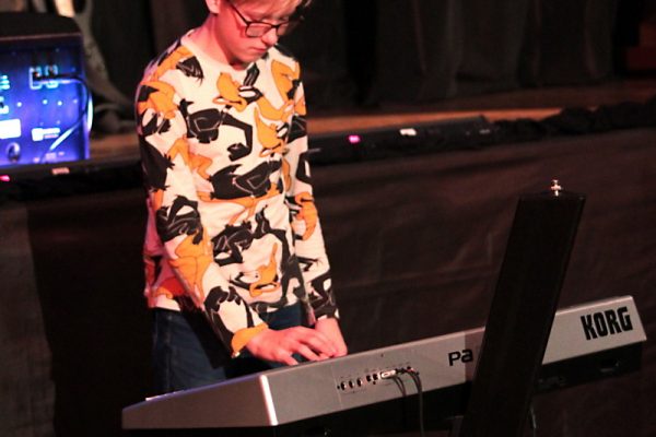 chłopak grający na keyboardzie