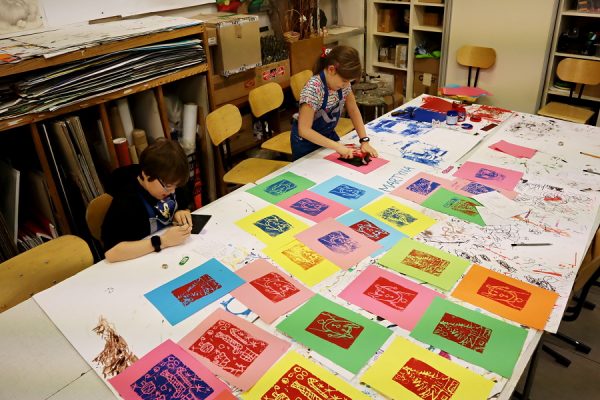 uczestnicy pracowni plastycznej podczas wykonywania odbitek