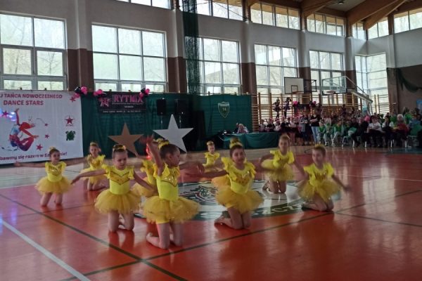 grupa dziewcząt w żółtych strojach w trakcie tańca