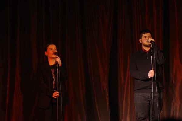 wokaliści na scenie przy mikrofonie