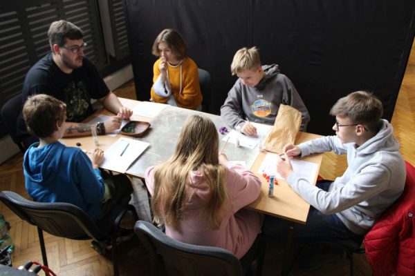 grupa uczestników przy stole podczas gry